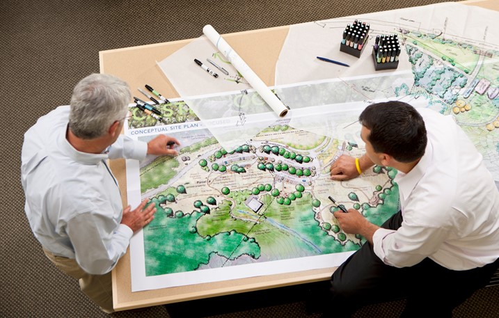 men looking at landscape plans